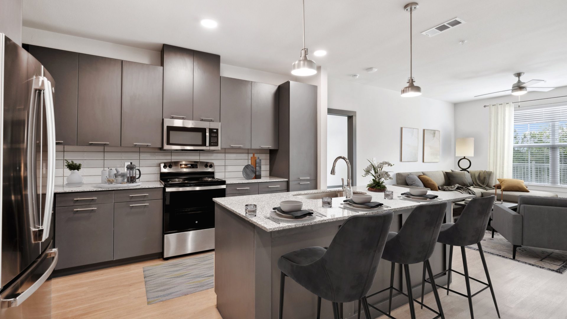 a kitchen with stainless steel appliances and a bar at The Legacy at Veramendi