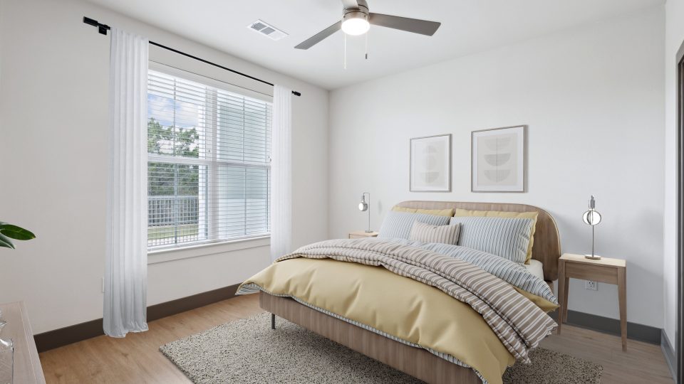 a bedroom with a ceiling fan and hardwood floors at The Legacy at Veramendi