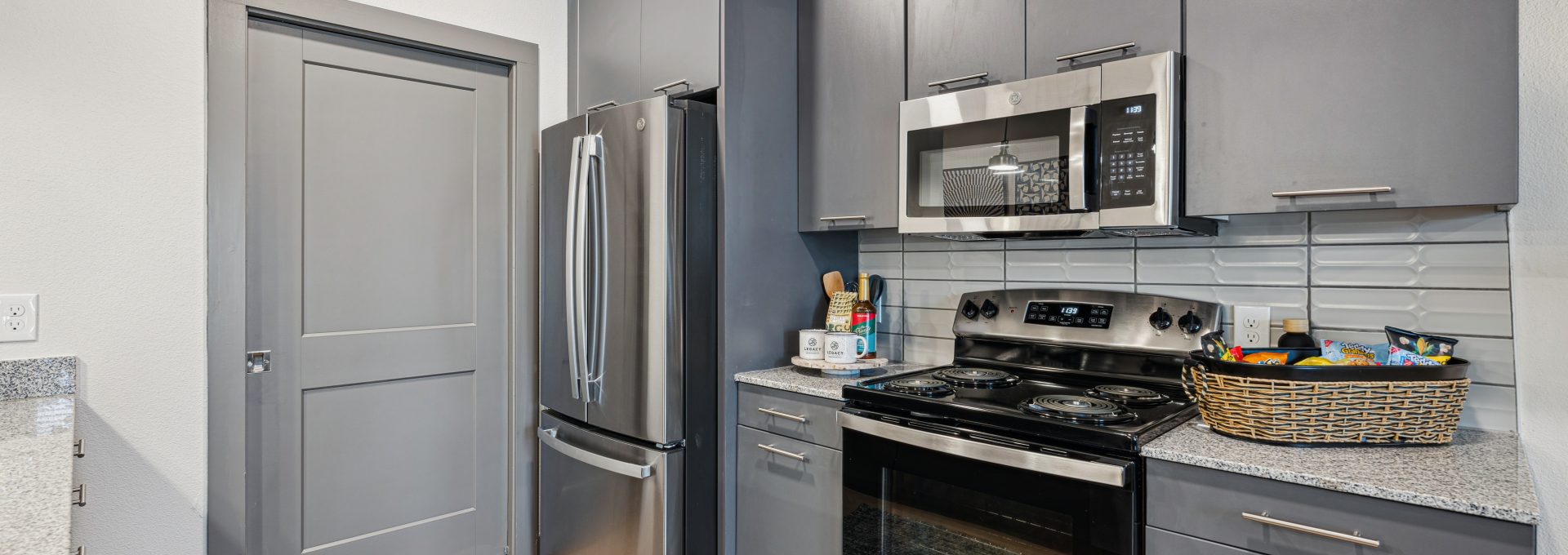 Elegant kitchen with quartz countertops, stainless steel appliances, and custom cabinetry in New Braunfels apartments.